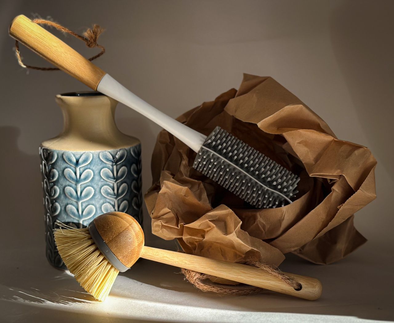 Crafting Captivating Headlines: Your awesome post title goes here Stylish still life of eco-friendly cleaning brushes, a textured ceramic vase, and crumpled brown paper.